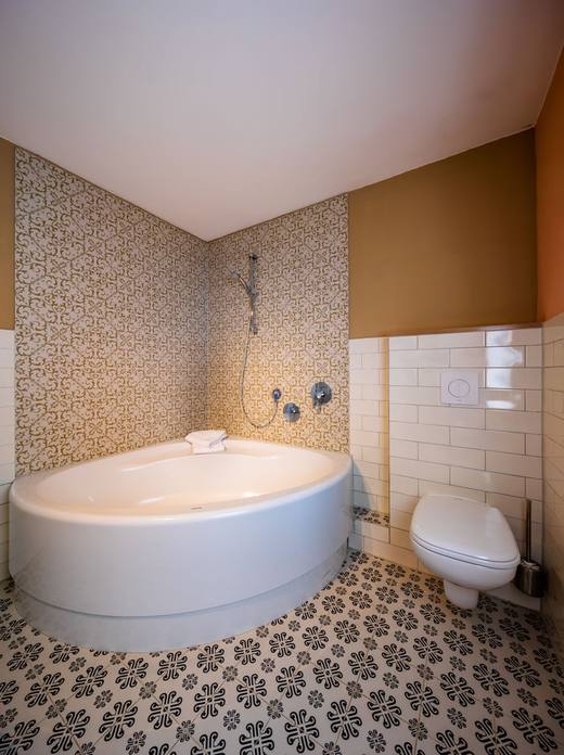 Bad mit Eckbadewanne und Musterfliesen